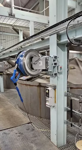 High-pressure stainless steel hose reel and trigger gun mounted to a support column as part of the washdown system at an industrial site in Burton with lance and gun
